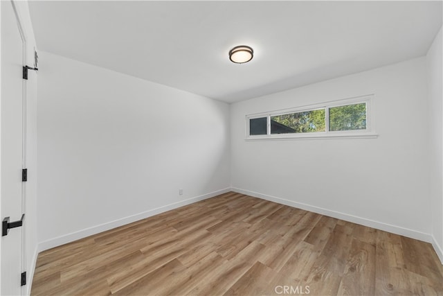 unfurnished room with light wood-type flooring