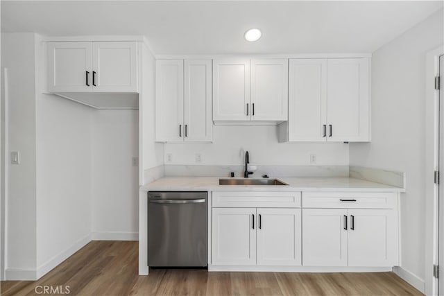 kitchen featuring white cabinetry, hardwood / wood-style flooring, sink, and stainless steel dishwasher