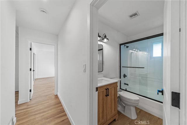 bathroom with wood-type flooring, vanity, and toilet