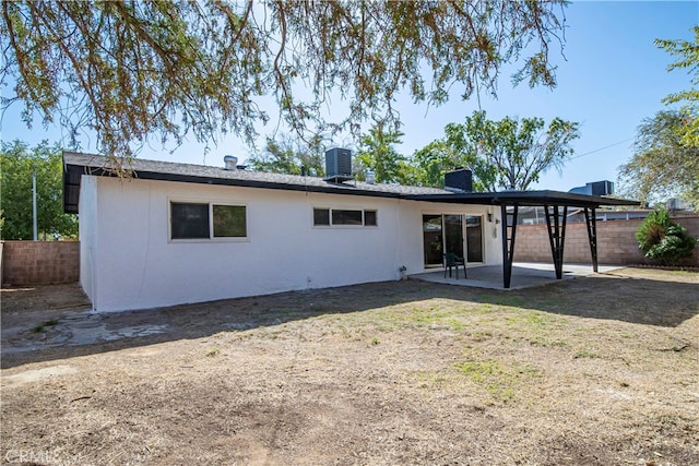 rear view of property featuring a patio area and central air condition unit