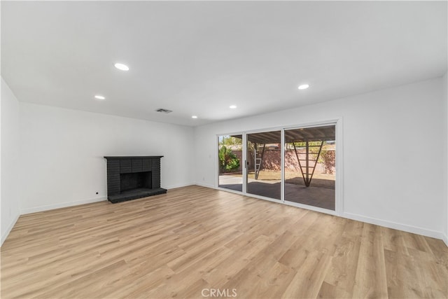 unfurnished living room featuring light hardwood / wood-style floors and a fireplace