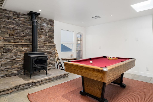 rec room with a wood stove and pool table