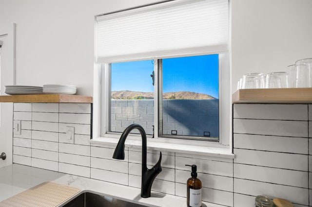 details with a mountain view, backsplash, and sink