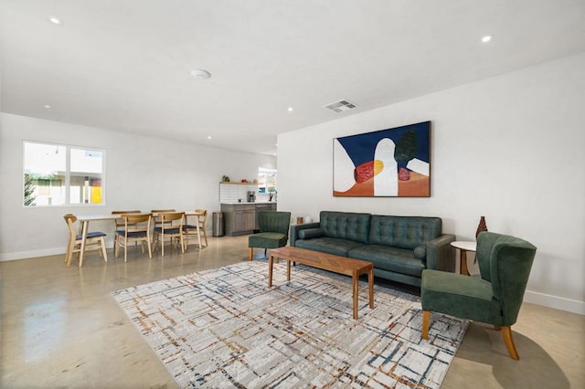 living room featuring concrete flooring