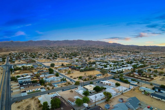 aerial view at dusk featuring a mountain view