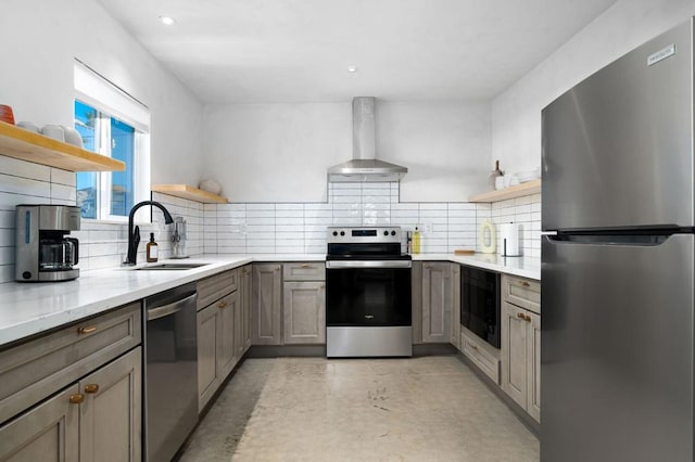 kitchen with sink, wall chimney exhaust hood, tasteful backsplash, light stone counters, and stainless steel appliances