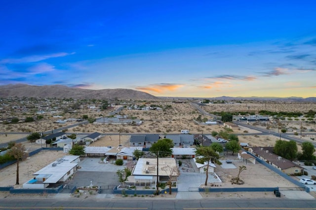 aerial view at dusk featuring a mountain view