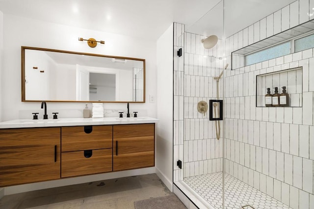 bathroom with vanity and a shower with door