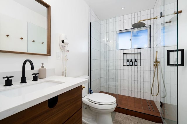 bathroom featuring vanity, toilet, and walk in shower