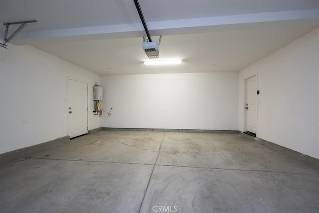 garage featuring water heater and a garage door opener