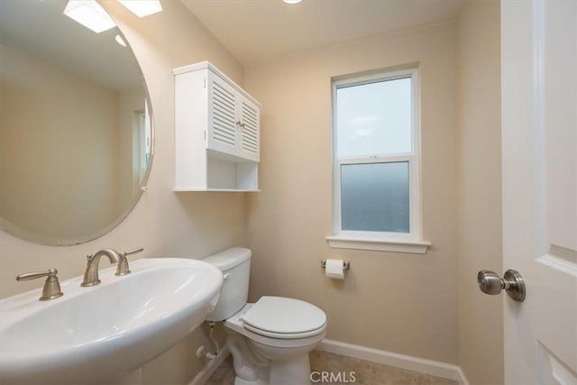 bathroom with tile patterned floors, toilet, and sink