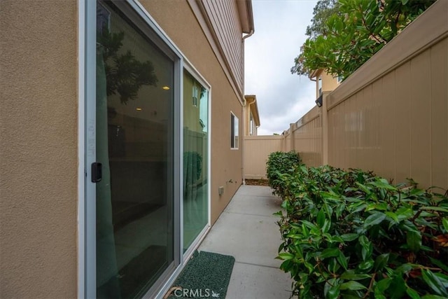 view of property exterior with a patio area