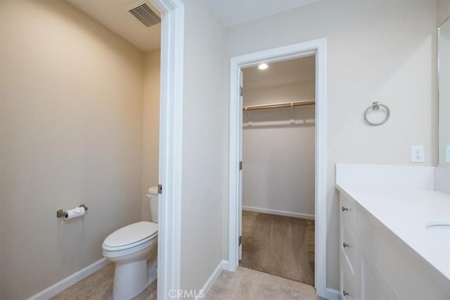 bathroom featuring tile patterned floors, vanity, and toilet