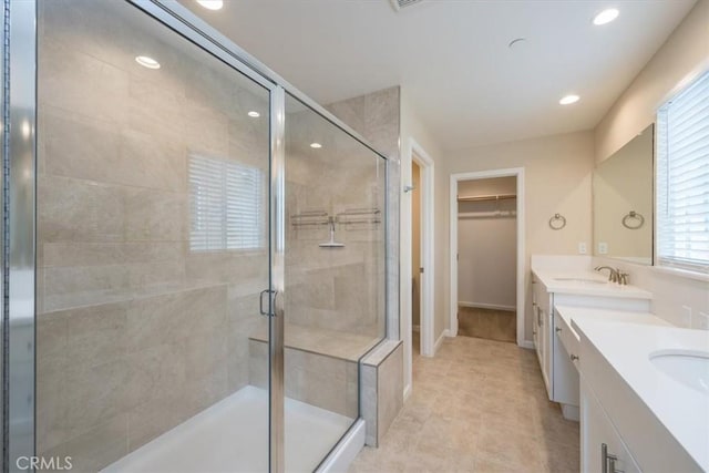 bathroom featuring vanity and an enclosed shower