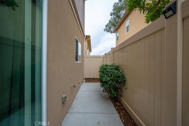 view of property exterior with a patio area