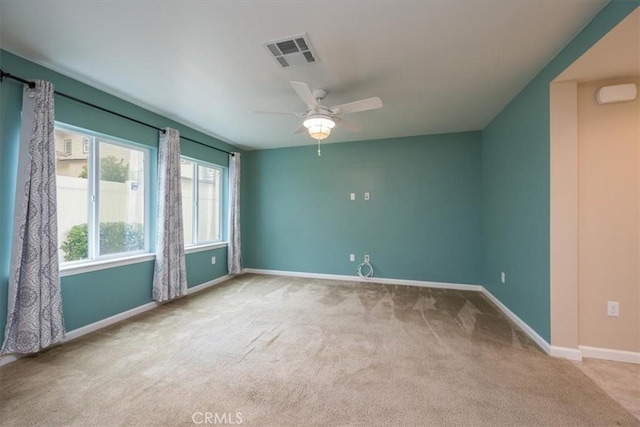 unfurnished room featuring ceiling fan and carpet