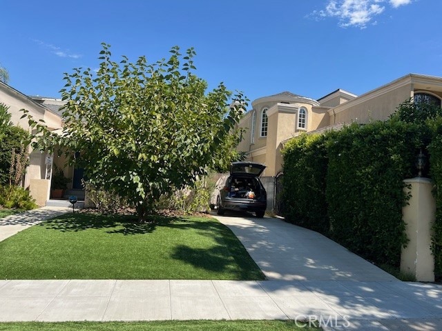 obstructed view of property featuring a front yard