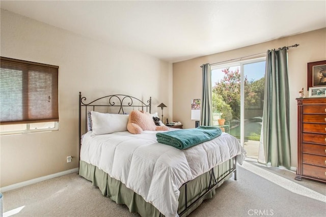 carpeted bedroom with access to exterior