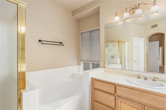 bathroom with vanity and independent shower and bath