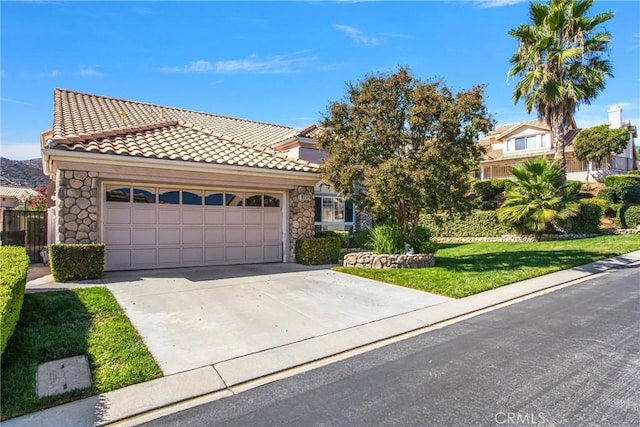 view of front of property featuring a garage and a front yard