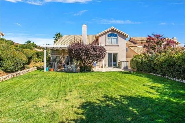 back of property with a patio and a lawn