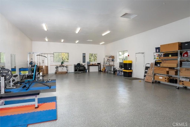 workout area with a towering ceiling