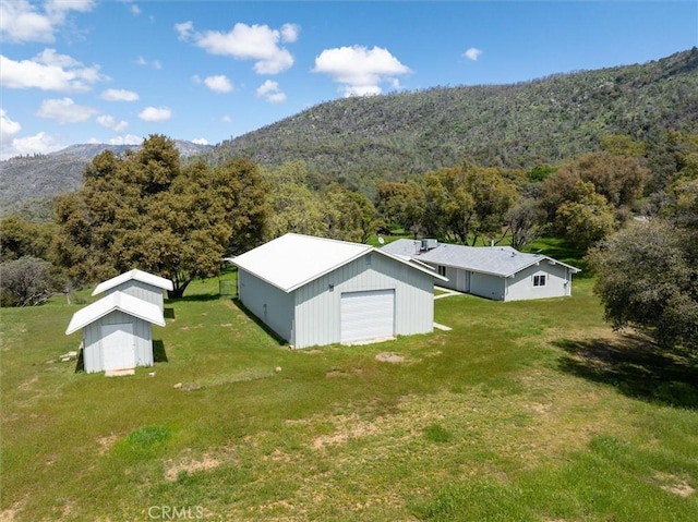 aerial view with a mountain view and a view of trees