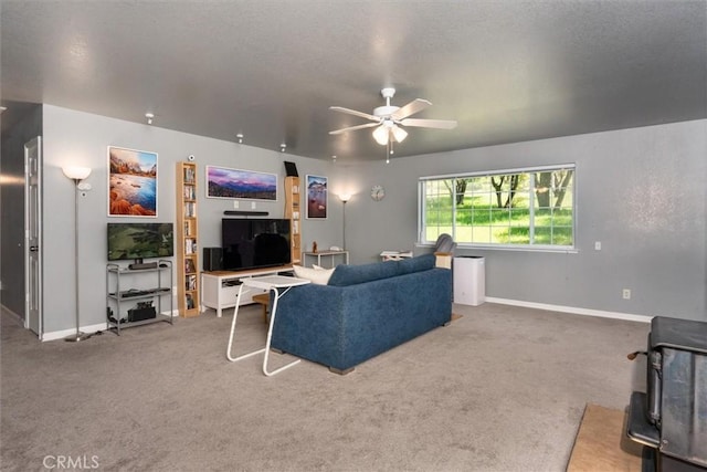31188 Tera Tera Ranch Rd, North Fork, CA 93643 - living room featuring carpet flooring, ceiling fan, and a wood stove