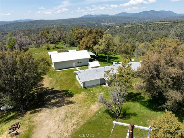 birds eye view of property with a forest view and a mountain view