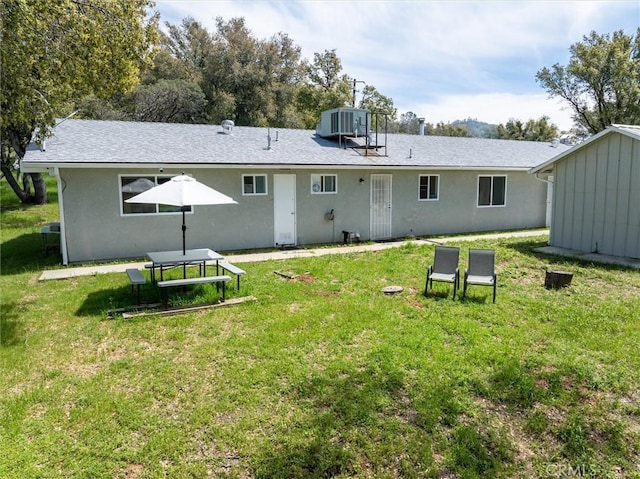 31188 Tera Tera Ranch Rd, North Fork, CA 93643 - rear view of property featuring a yard, stucco siding, and a storage unit