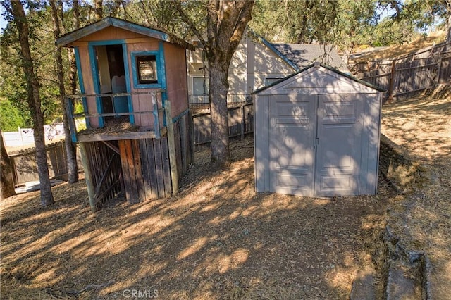 view of shed with fence