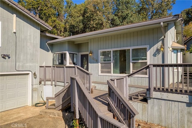 exterior space featuring a garage, stairs, and a deck