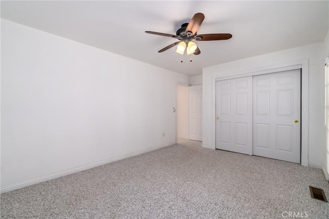 unfurnished bedroom featuring a closet, visible vents, light carpet, and baseboards