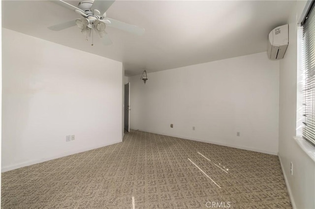 carpeted empty room with an AC wall unit, ceiling fan, and baseboards