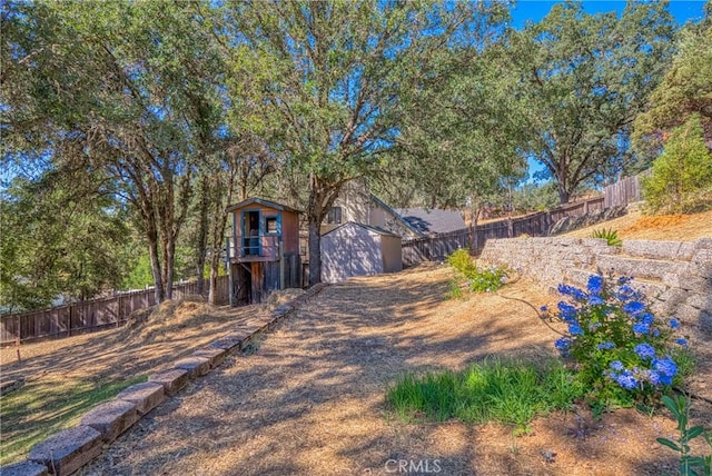 view of yard with an outbuilding and a fenced backyard