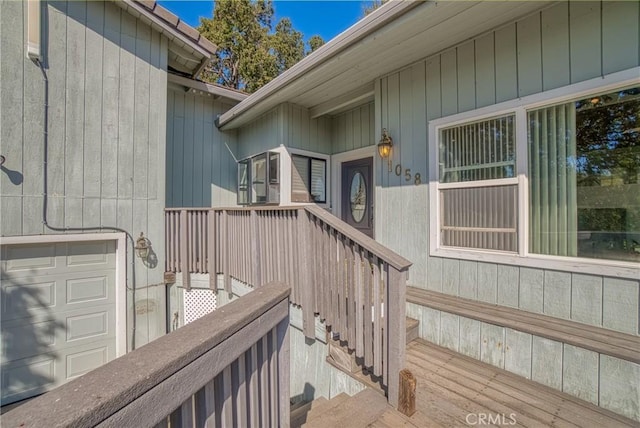 doorway to property featuring a garage and a deck