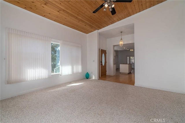 spare room with carpet floors, a wealth of natural light, wooden ceiling, and lofted ceiling