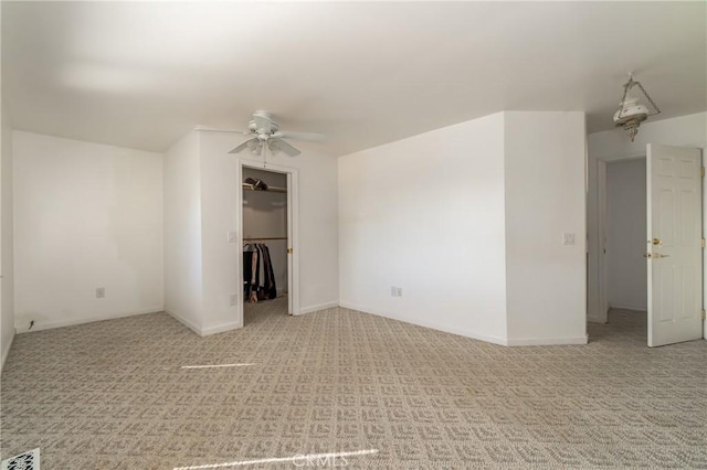 unfurnished room with light carpet, ceiling fan, visible vents, and baseboards