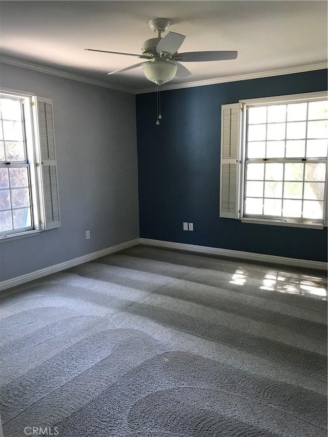 unfurnished room featuring carpet flooring, ornamental molding, and a wealth of natural light