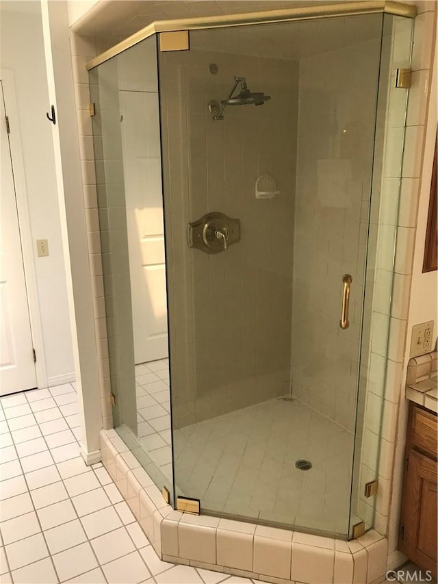 bathroom featuring tile patterned flooring, vanity, and an enclosed shower