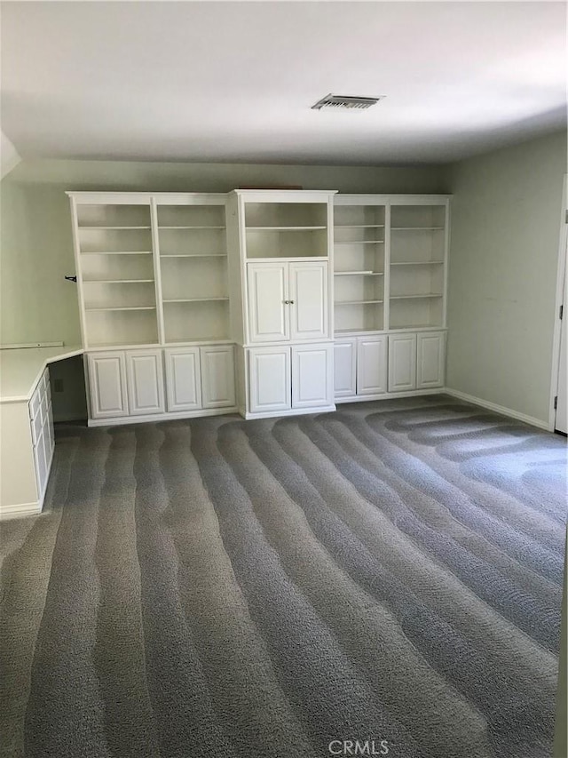 unfurnished bedroom with dark colored carpet