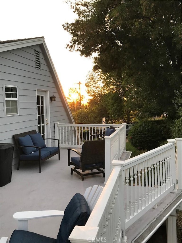 patio terrace at dusk featuring an outdoor hangout area