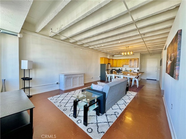 living room with concrete floors and a chandelier