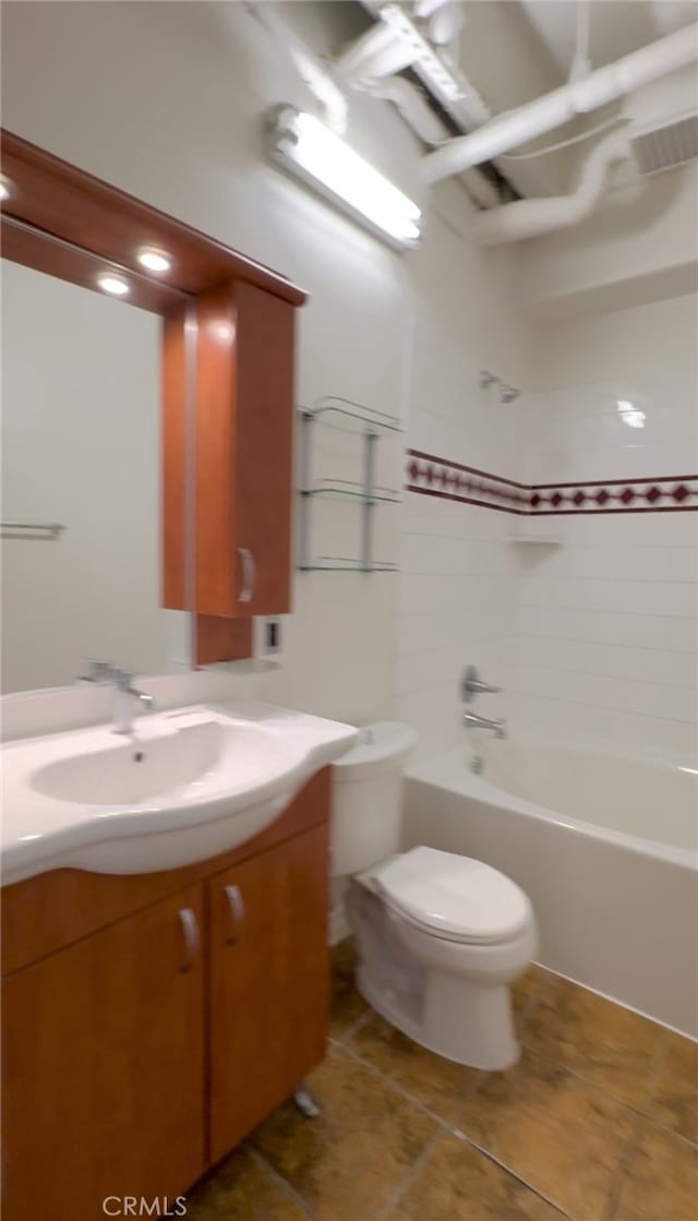 full bathroom with vanity, tiled shower / bath combo, toilet, and tile patterned floors