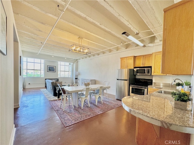 dining area with a chandelier and sink