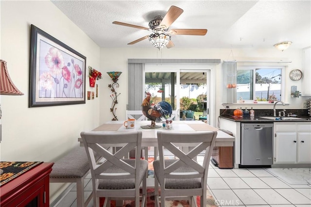 dining space featuring a textured ceiling, ceiling fan, and sink