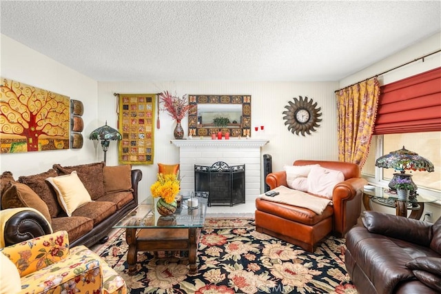 living room featuring a textured ceiling and a brick fireplace