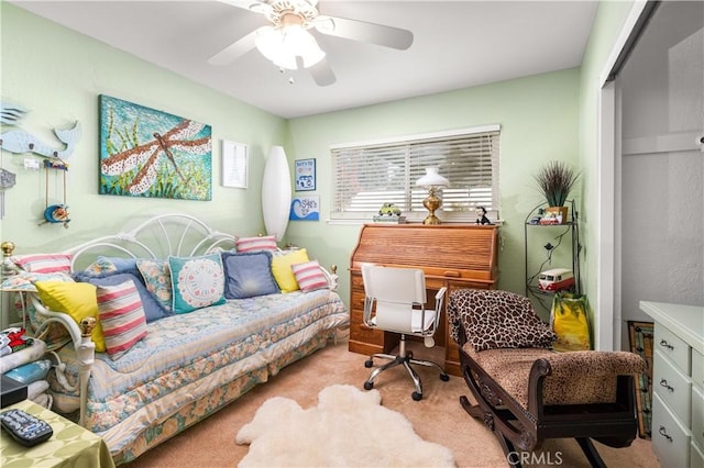 carpeted office space with ceiling fan