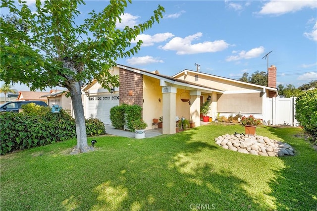 back of property with a yard and a garage