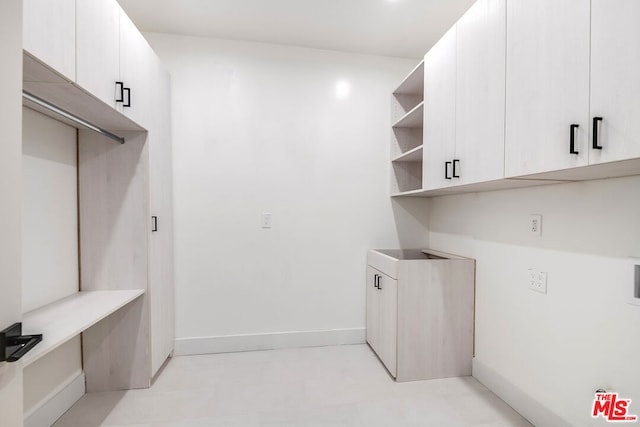 laundry area with cabinets